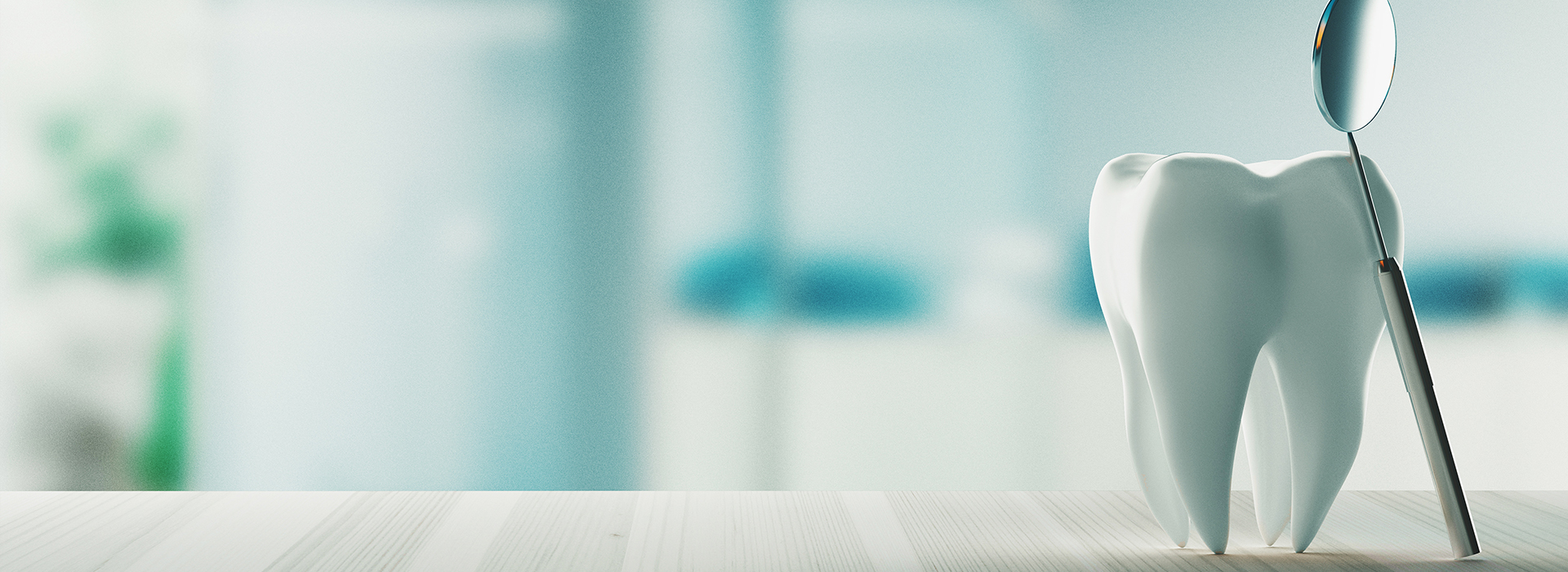 This is an image of a dental office with a focus on a toothbrush and a tooth model, set against a blurred background featuring a person s arm holding a spoon.